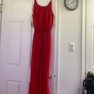 A jumpsuit,spaghetti straps,slits on the bottom